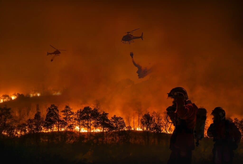 Fire fighters and helicopters work to extinguish a forest fire, Shutterstock ID#2569473245