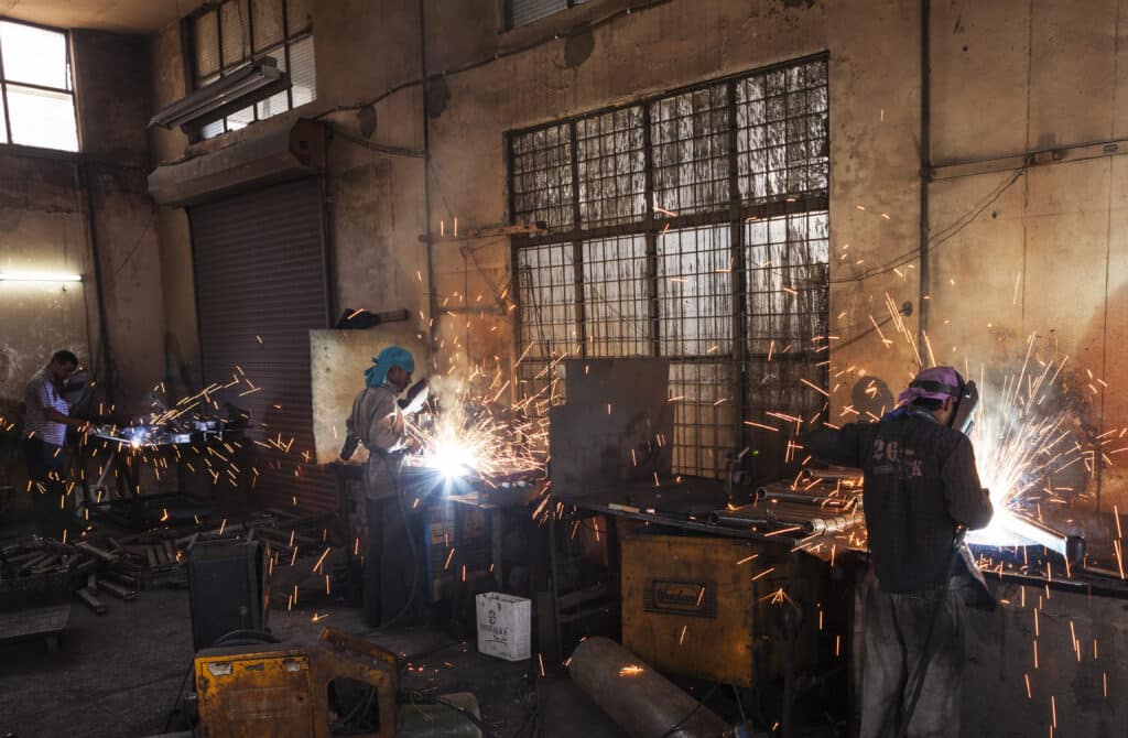 Workers welding in a factory, Ludhiana, Punjab, India, Shutterstock ID#751671301